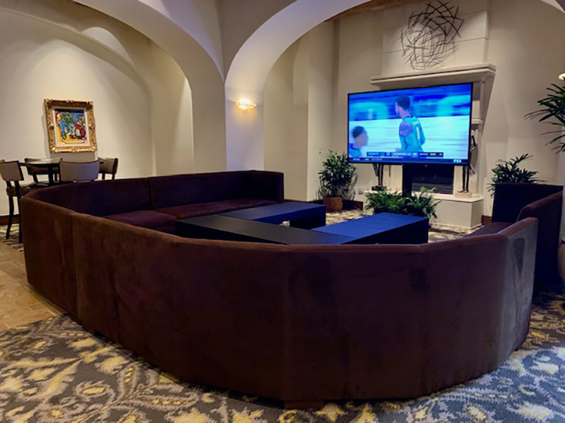 Huge oversized chocolate brown suede sectional with large beefy cocktail tables in a horseshoe shape