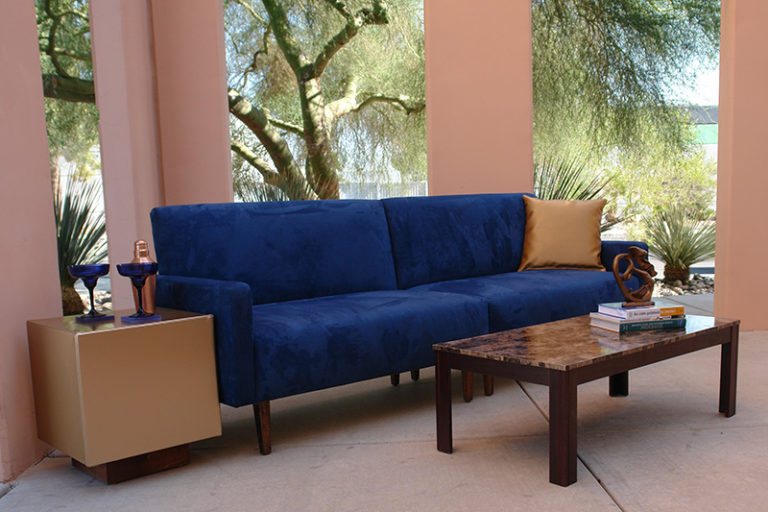 Blue suede sofa with cube charging tables and brown marbel cocktail table outside