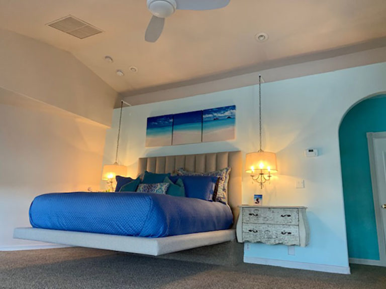 Custom floating California King bed and padded headboard for beach themed bedroom by Somers Furniture