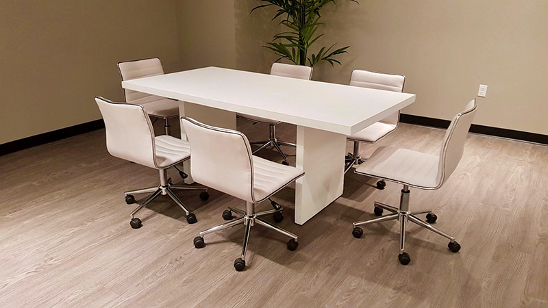meeting room with 6’ white conference table with low back executive chairs without arms rental furniture from Somers Furniture rental in las vegas