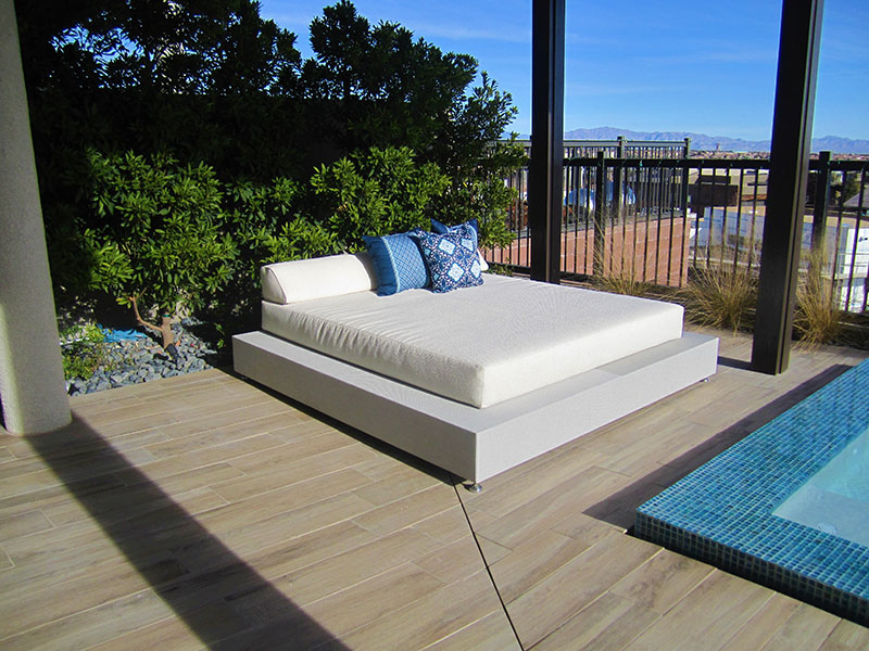 Gray base with white cushioned daybed with watercolor pillows by somers furniture in las vegas